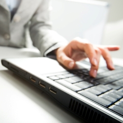 accountants for physiotherapists - Close-up of female hand on mouse while working on laptop